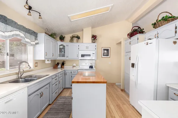 a kitchen with refrigerator a sink and cabinets