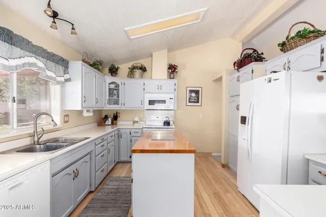 a kitchen with refrigerator a sink and cabinets