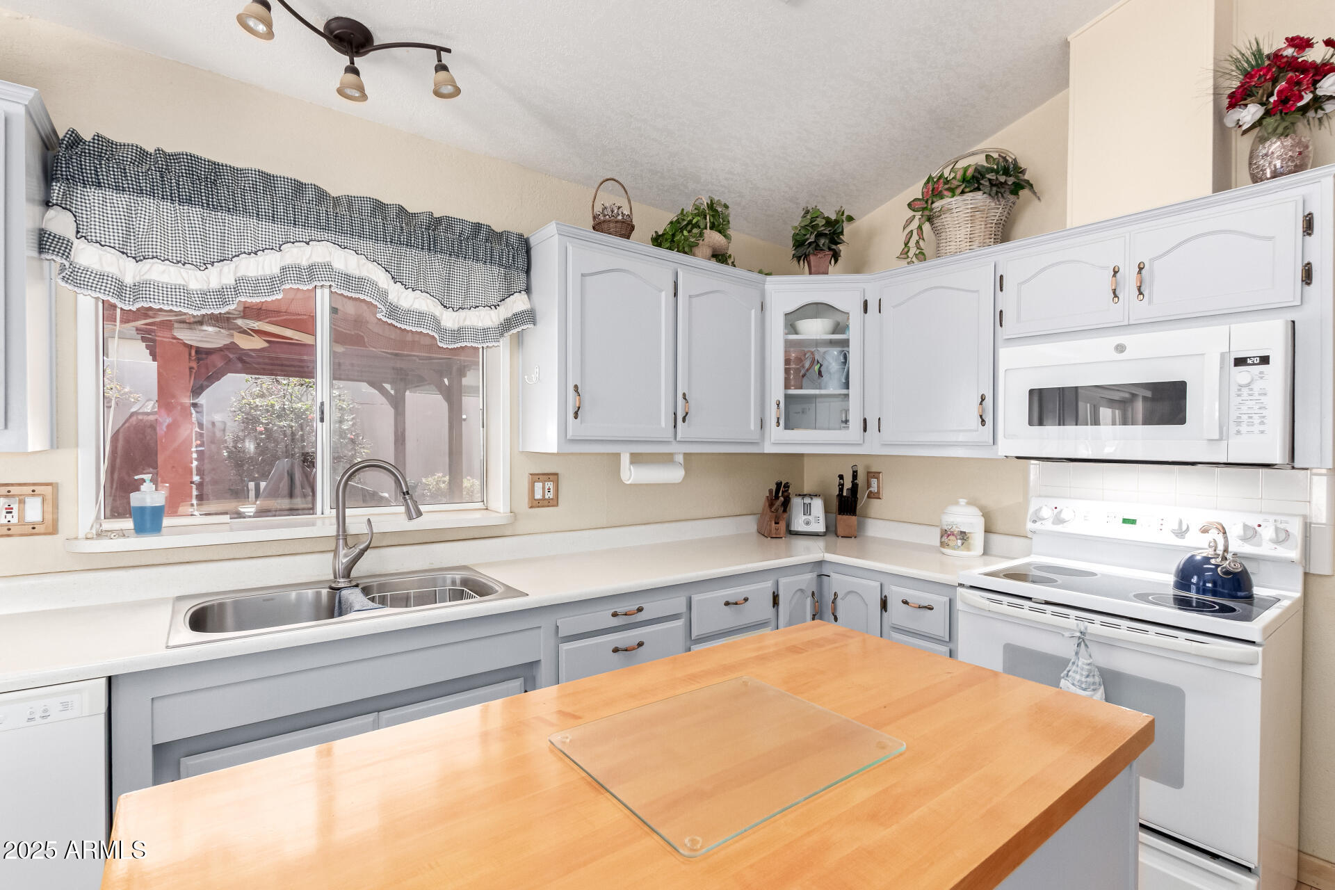 2101 South Meridian Road, Unit 60 Apache Junction, AZ 85120 - Photo 15 of 35 a kitchen with a sink a stove and cabinets