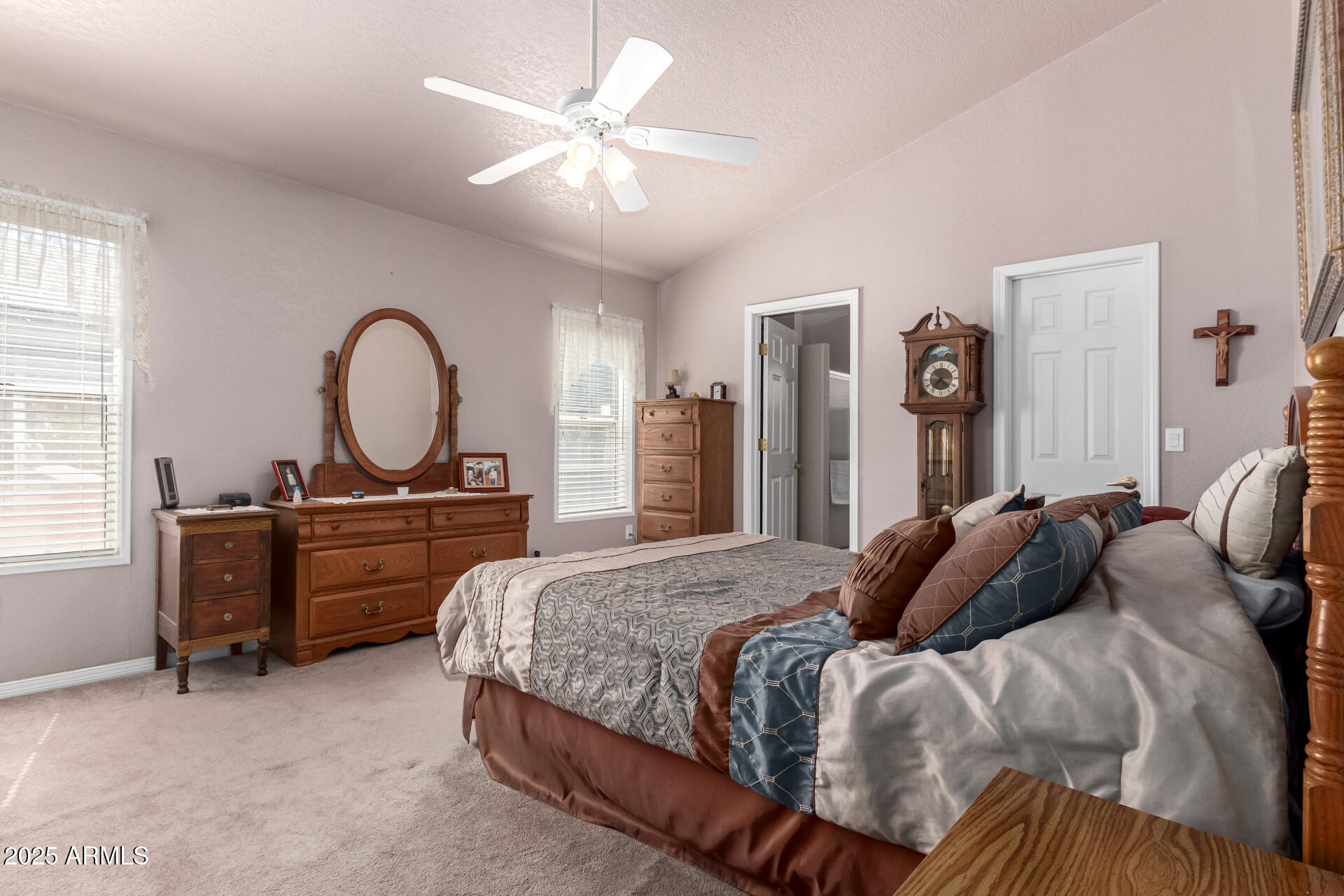 2101 South Meridian Road, Unit 60 Apache Junction, AZ 85120 - Photo 17 of 35 a bedroom with a bed and a chandelier