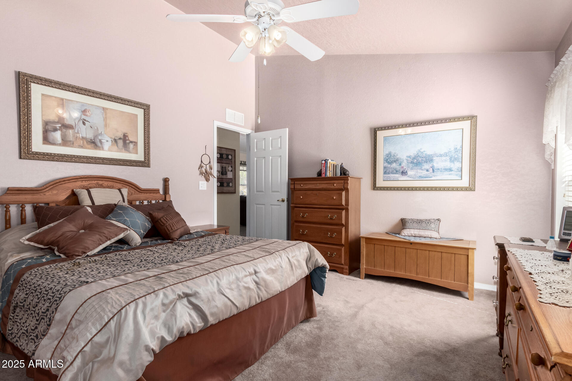 2101 South Meridian Road, Unit 60 Apache Junction, AZ 85120 - Photo 18 of 35 a bedroom with a bed and a chandelier