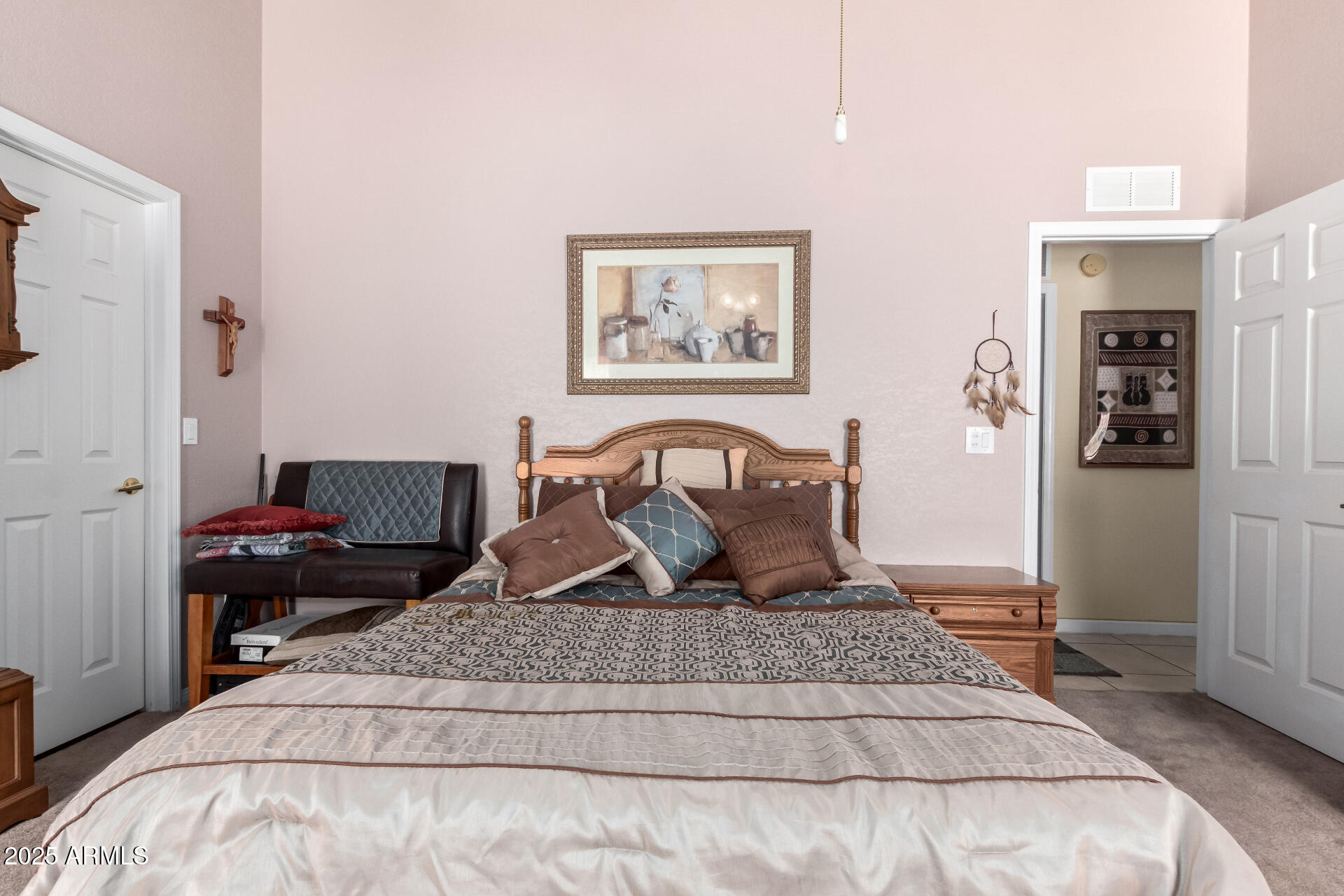 2101 South Meridian Road, Unit 60 Apache Junction, AZ 85120 - Photo 19 of 35 a bedroom with a large bed and a chandelier