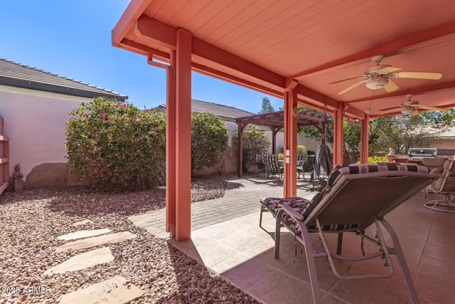 a view of a patio with a table and chairs under an umbrella
