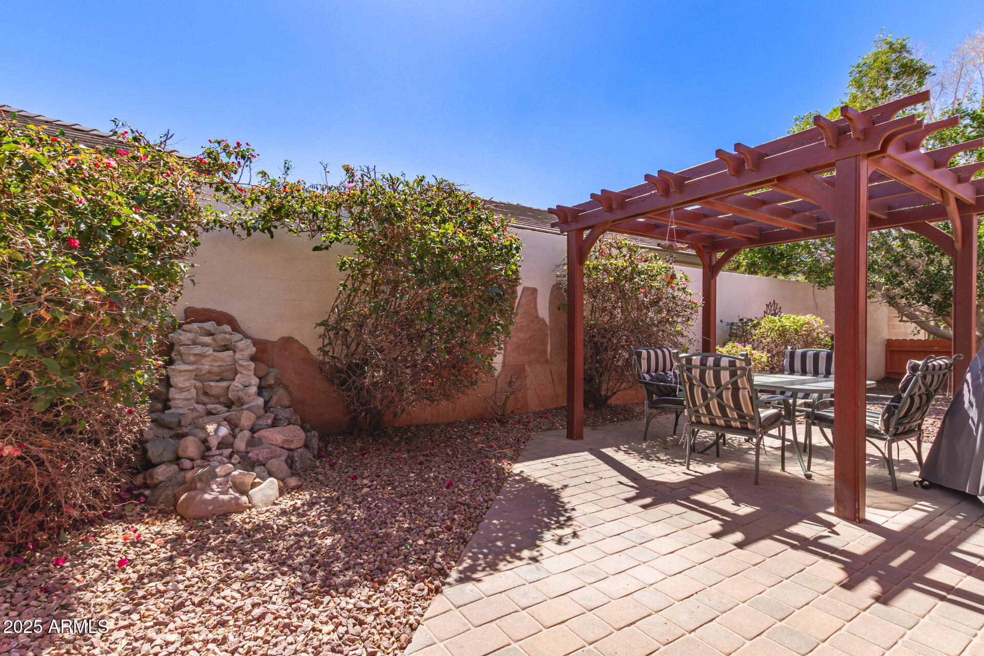 2101 South Meridian Road, Unit 60 Apache Junction, AZ 85120 - Photo 32 of 35 a view of a patio with a table and chairs under an umbrella