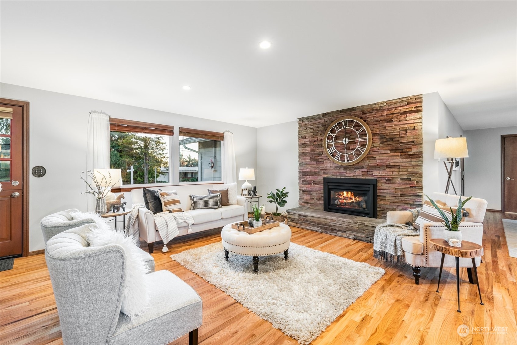 3306 Northeast 11th Street Renton, WA 98056 - Photo 5 of 40 a living room with furniture a fireplace and a large window