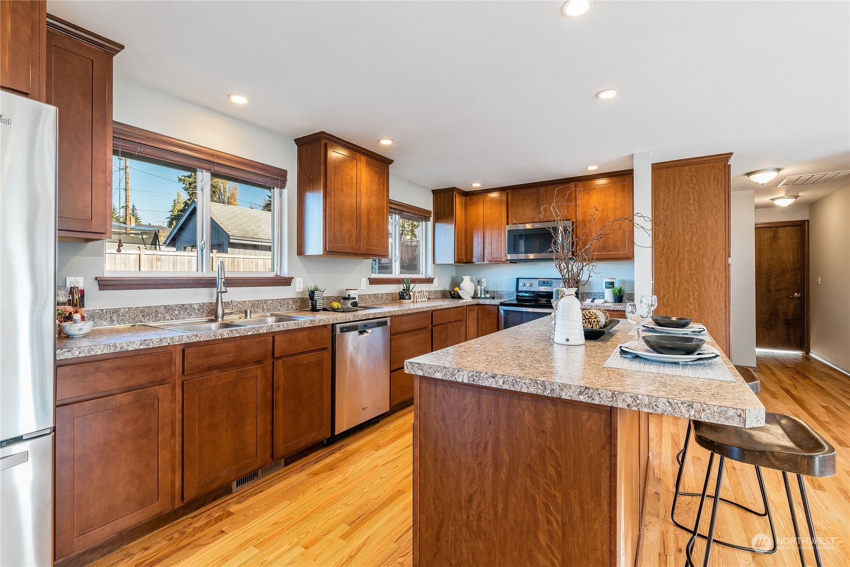 3306 Northeast 11th Street Renton, WA 98056 - Photo 9 of 40 a kitchen with stainless steel appliances granite countertop sink stove and refrigerator