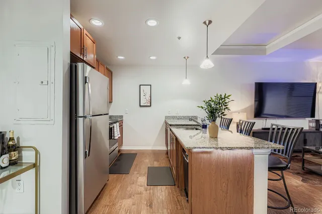 a dining room with furniture and wooden floor