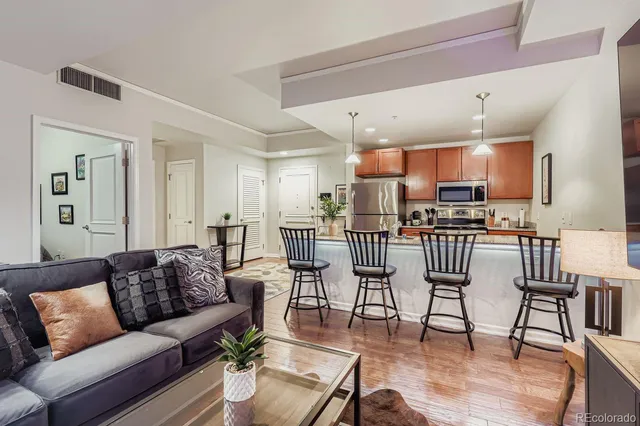 a living room kitchen with furniture and a dining table with kitchen view