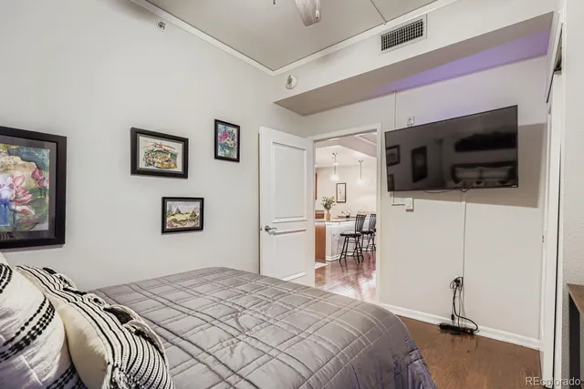 a bedroom with a bed and a flat screen tv