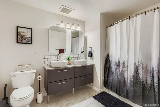 a bathroom with a toilet a sink and a mirror