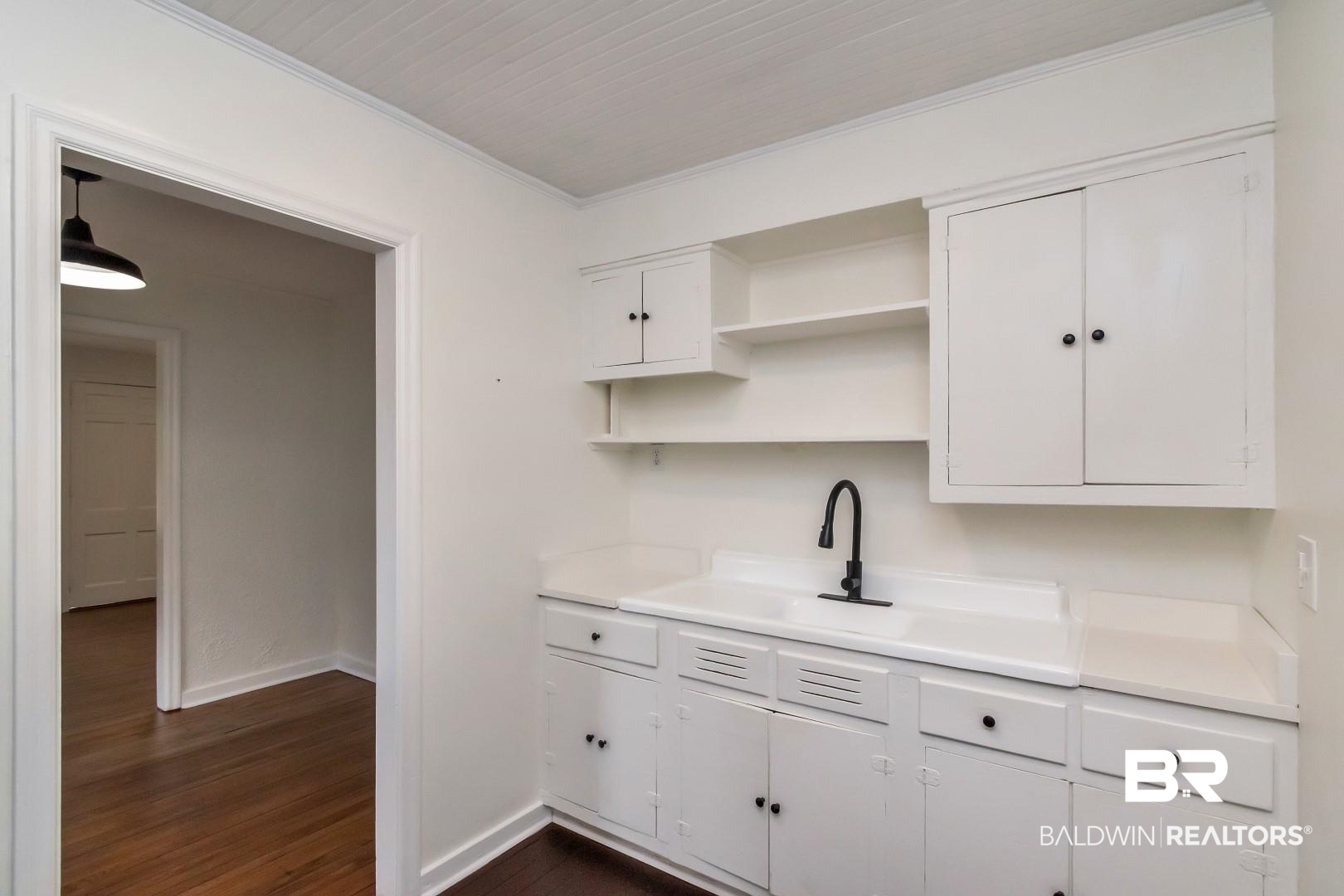 208 Morgan Avenue Mobile, AL 36606 - Photo 13 of 27 Kitchen with white cabinets, sink, crown molding, and dark hardwood / wood-style flooring