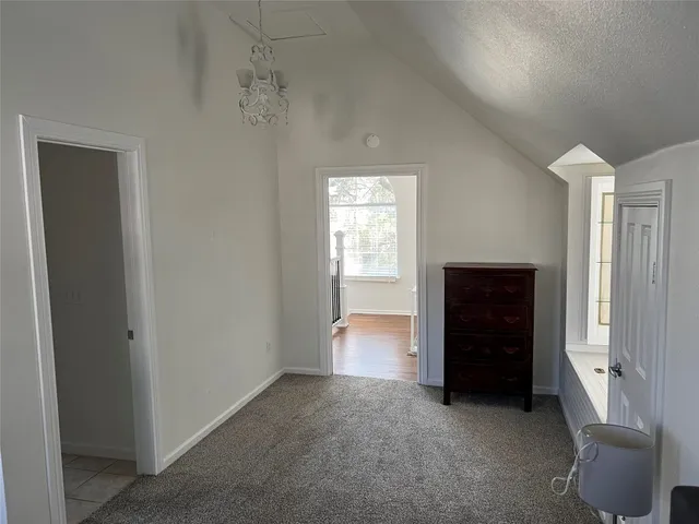 an empty room with a door and a window