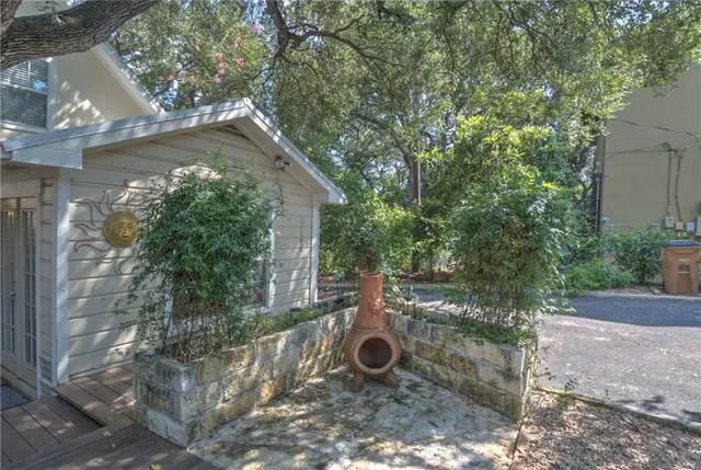 a backyard of a house with barbeque oven