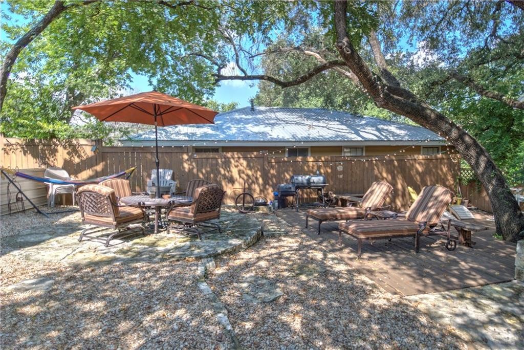2404 Thornton Road, Unit A Austin, TX 78704 - Photo 27 of 31 a view of a patio with table and chairs under an umbrella