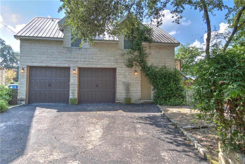 2404 Thornton Road, Unit A Austin, TX 78704 - Photo 28 of 31 a front view of a house with a yard and garage