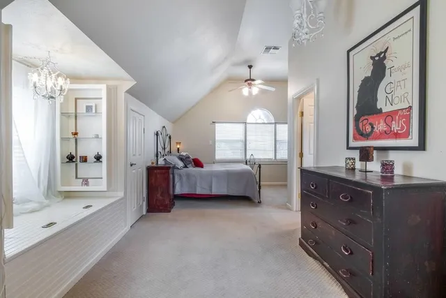 a spacious bedroom with a bed and a dresser