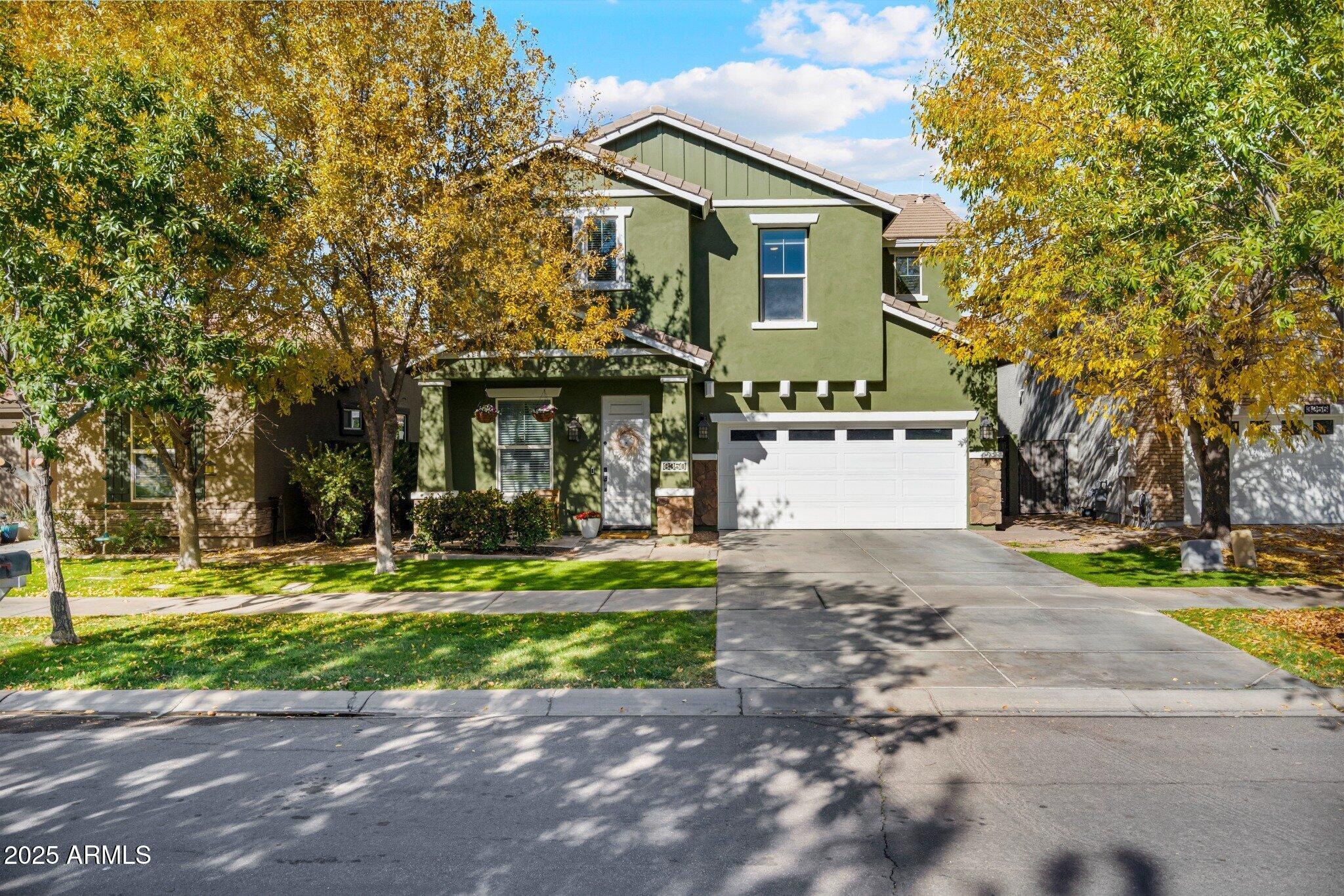 a front view of a house with a yard and garage