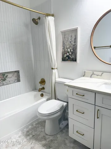 a view of staircase with lots of frames on wall and wooden floor