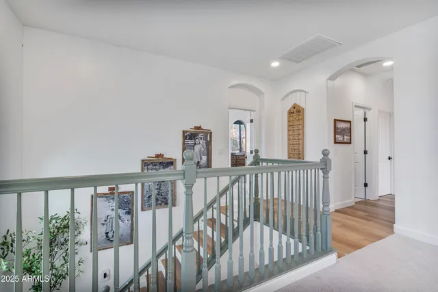 a bedroom with a bed and a chandelier fan
