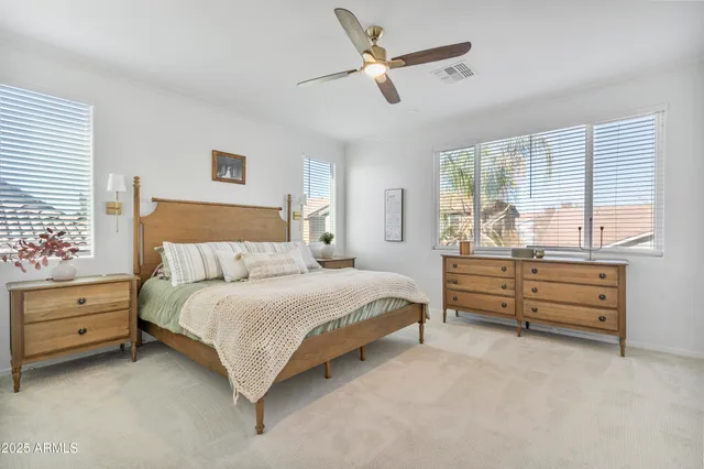 a bedroom with a bed and a large window