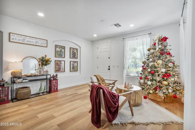 a living room with furniture and flowers