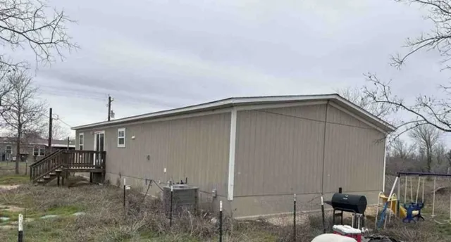 a backyard of a house with table and chairs