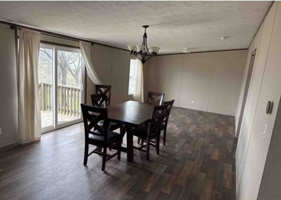 1580 Pooley Road Kingsbury, TX 78638 - Photo 4 of 11 a view of a dining room with furniture window and wooden floor