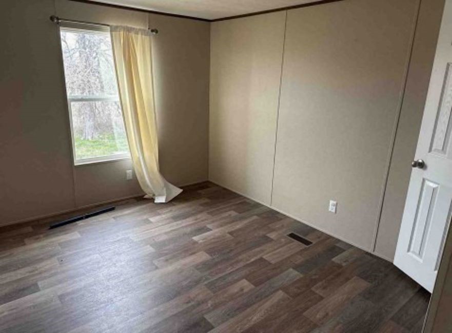1580 Pooley Road Kingsbury, TX 78638 - Photo 6 of 11 an empty room with wooden floor and windows