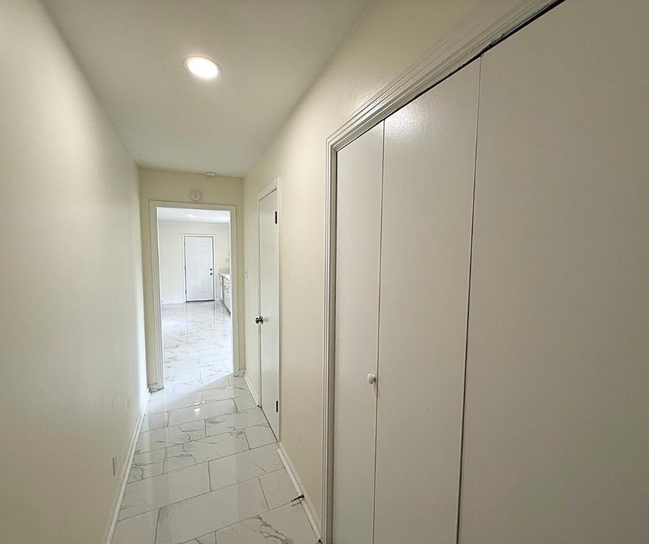 3969 Millbranch Road Memphis, TN 38116 - Photo 12 of 33 Hallway featuring light marble finish floors and recessed lighting