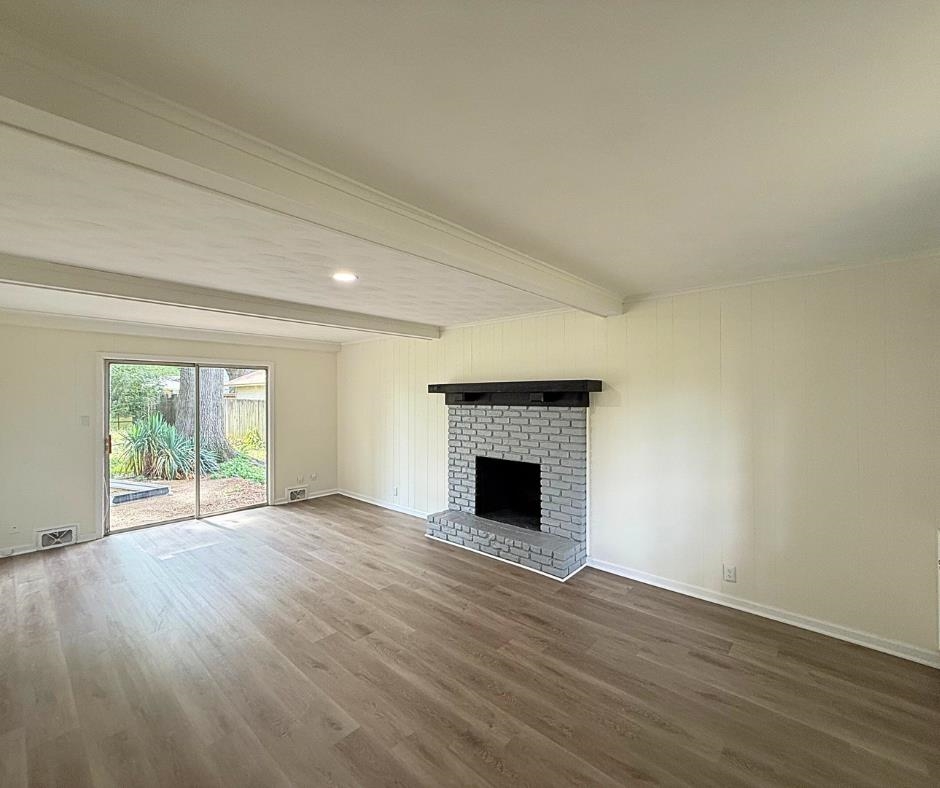 3969 Millbranch Road Memphis, TN 38116 - Photo 16 of 33 Unfurnished living room with beam ceiling, dark wood-style flooring, a fireplace, and recessed lighting