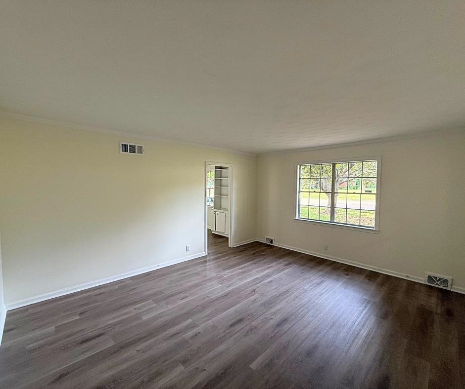 3969 Millbranch Road Memphis, TN 38116 - Photo 19 of 33 Empty room with dark wood-style floors and baseboards