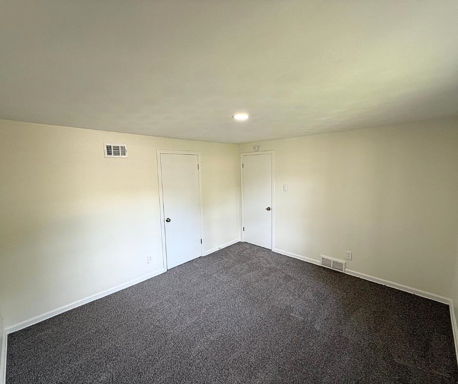 3969 Millbranch Road Memphis, TN 38116 - Photo 21 of 33 Spare room with dark colored carpet and recessed lighting
