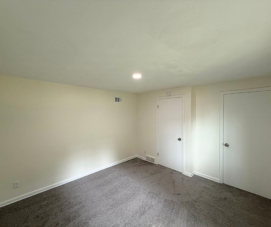 3969 Millbranch Road Memphis, TN 38116 - Photo 25 of 33 Unfurnished bedroom with dark carpet and baseboards