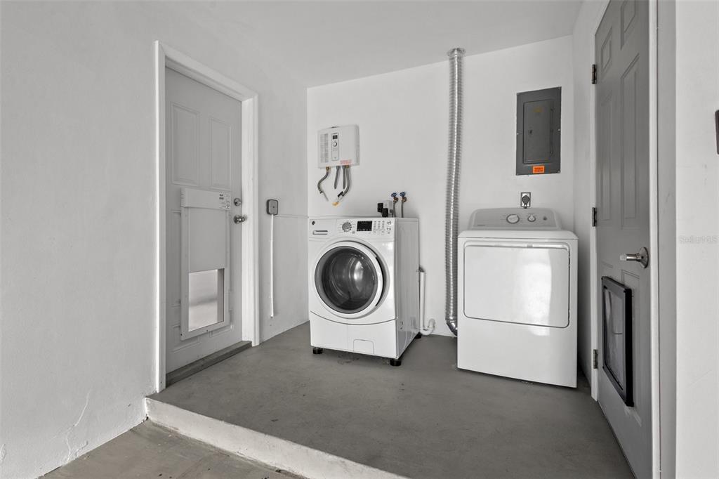 2033 Little Neck Road Clearwater, FL 33755 - Photo 30 of 39 Separate laundry area showing newer washer & dryer and new tankless water heater.