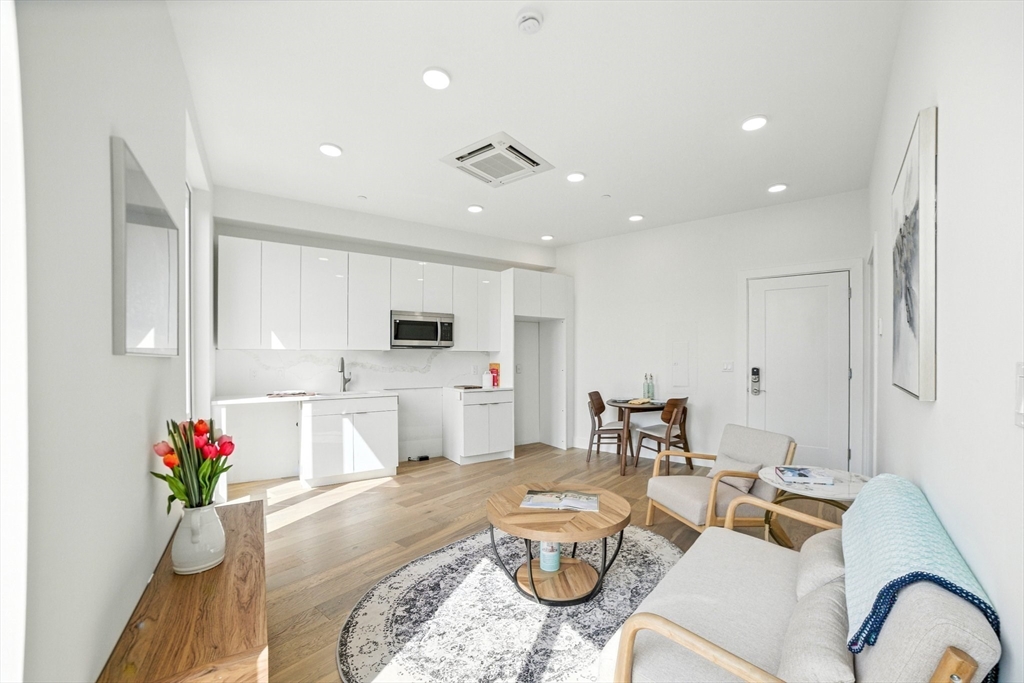 38 Hichborn Street, Unit 505 Boston, MA 02135 - Photo 2 of 9 a living room with furniture and kitchen view