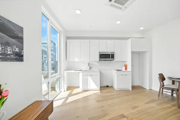 a view of a kitchen with microwave and cabinets