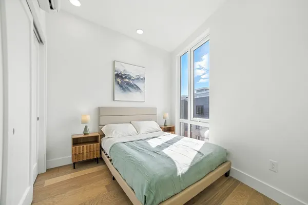 a bedroom with a bed and a window