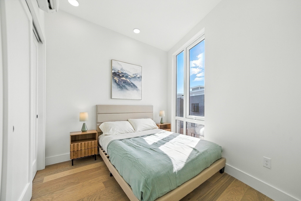 38 Hichborn Street, Unit 505 Boston, MA 02135 - Photo 5 of 9 a bedroom with a bed and a window