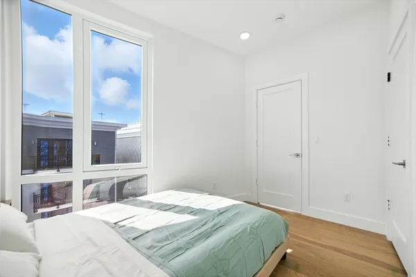 a bedroom with a bed and glass window