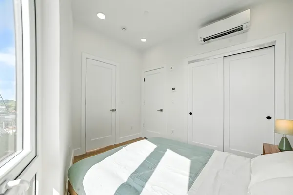 a bedroom with a bed and a window