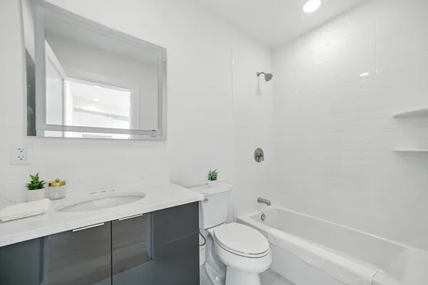 a bathroom with a sink toilet and shower