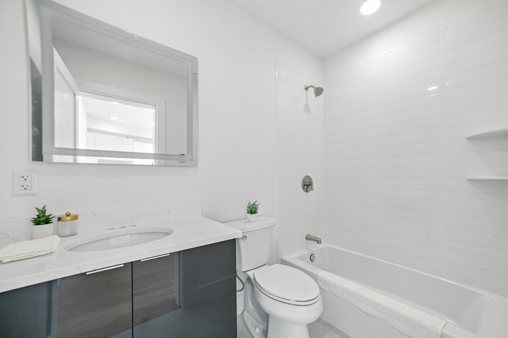38 Hichborn Street, Unit 505 Boston, MA 02135 - Photo 9 of 9 a bathroom with a sink toilet and shower
