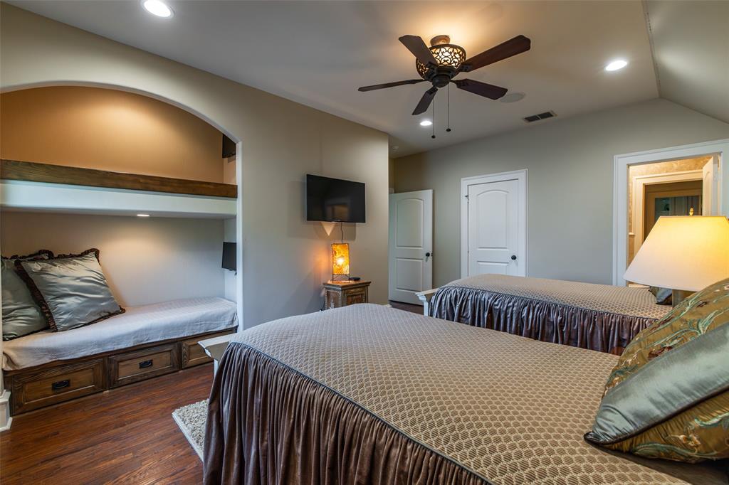 325 Young Road Hallsville, TX 75650 - Photo 23 of 39 a bedroom with a bed and a chandelier