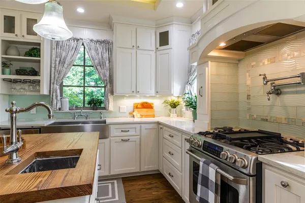 a living room with furniture kitchen view and a large window