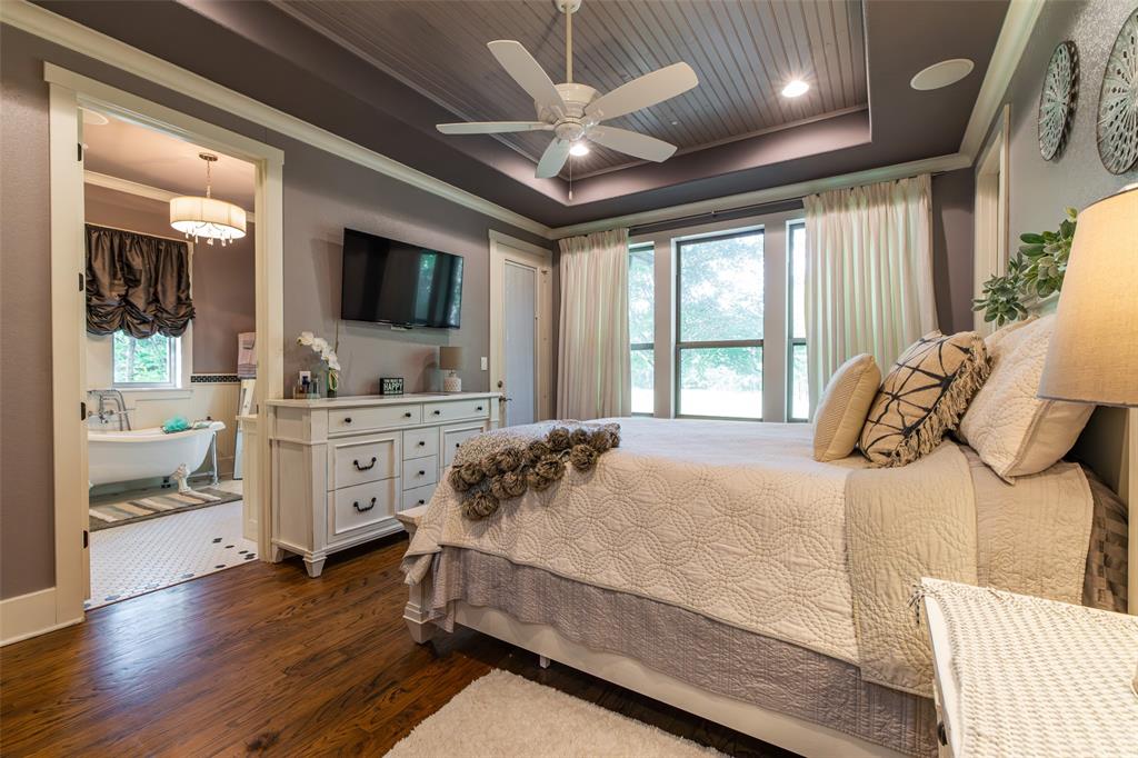 325 Young Road Hallsville, TX 75650 - Photo 34 of 39 a bedroom with a large bed and a tv