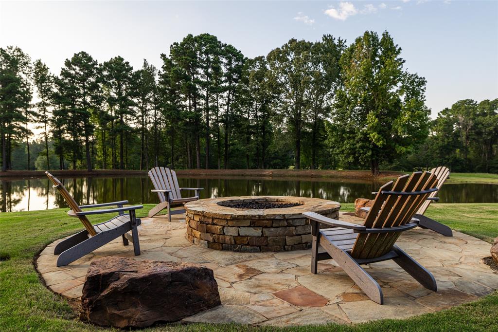 325 Young Road Hallsville, TX 75650 - Photo 38 of 39 a view of a chairs and fire pit in the backyard