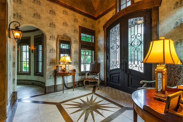 a living room with furniture a fireplace and a chandelier