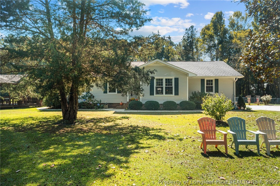 1533 Carl Freeman Road Stedman, NC 28391 - Photo 8 of 48 a front view of a house with swimming pool and porch