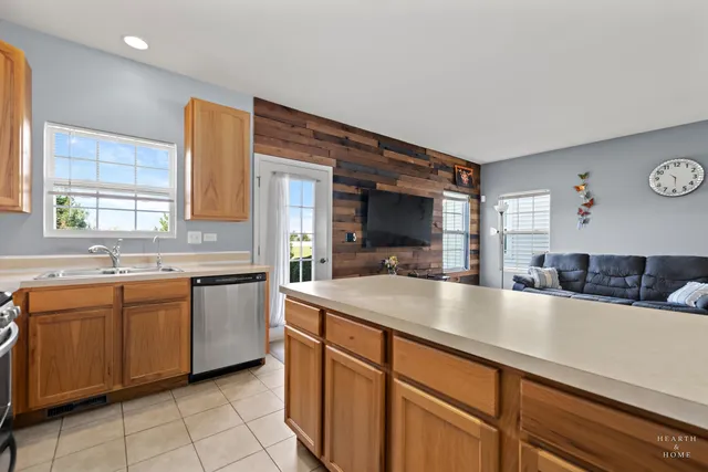 a kitchen with stainless steel appliances granite countertop a sink and a stove