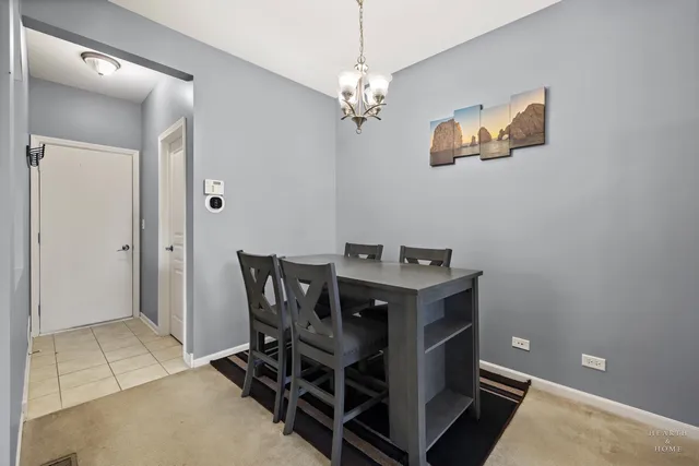 a view of a dining room with furniture and chandelier fan
